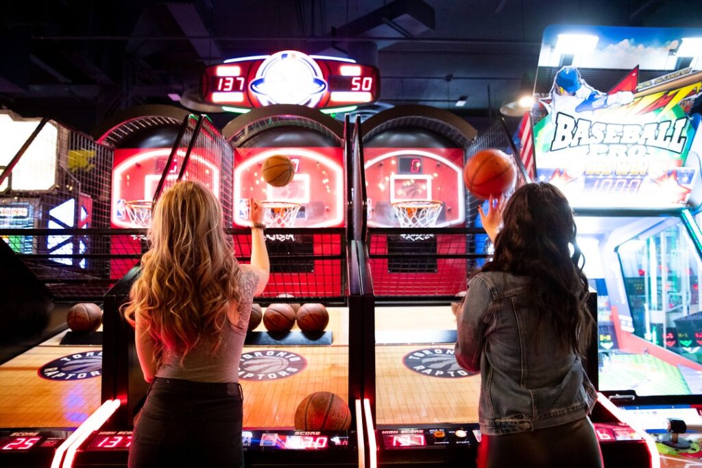 two friends playing an arcade game